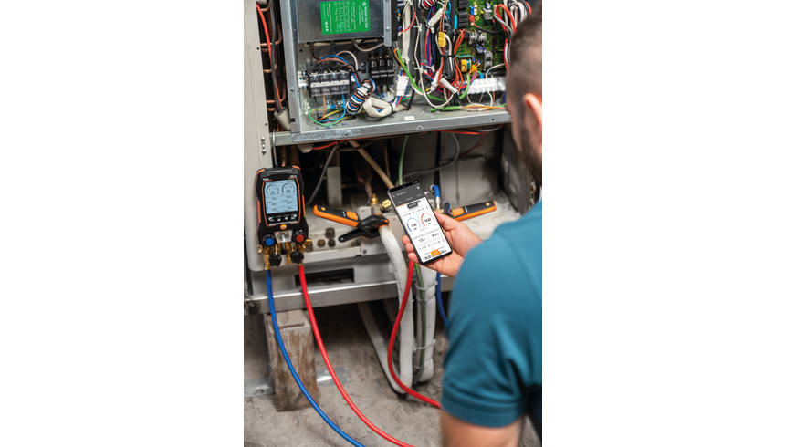 Technician using Testo 557s with smart app during HVAC diagnostics